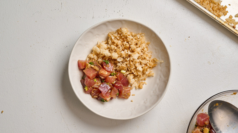 rice and tuna in a bowl on a table