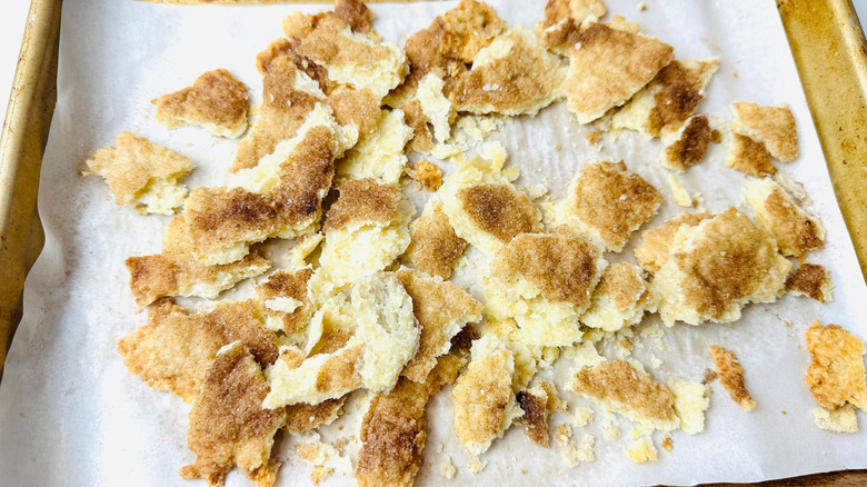 Pie crust broken into chunks on baking sheet
