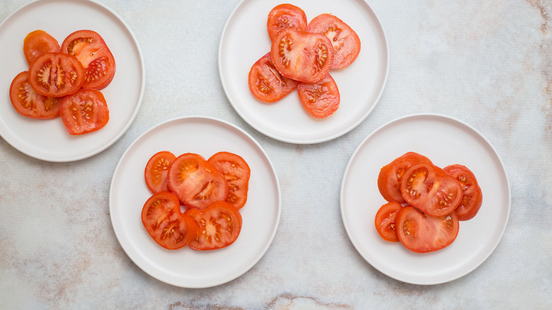 tomato slices on four plates