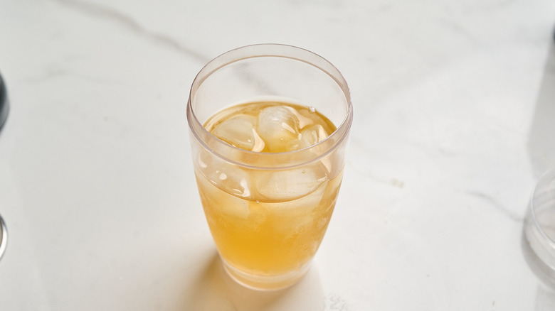 whiskey, pineapple juice, and vermouth in a cocktail shaker