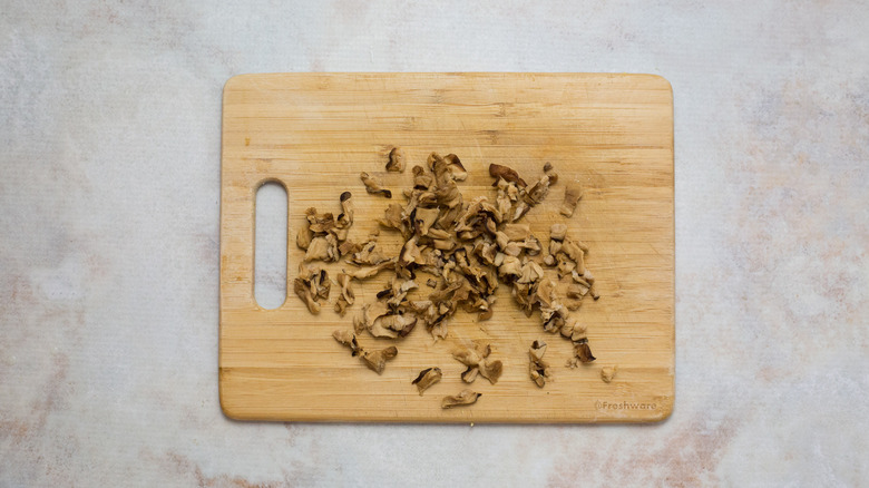 chopped mushrooms on wooden board