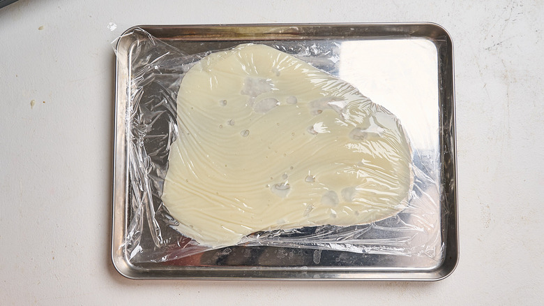 chilling milk mixture on a sheet tray