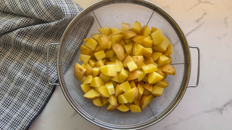 Cubed potatoes in colander