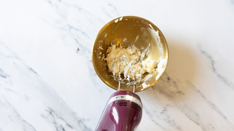 Whipping cream cheese in bowl.