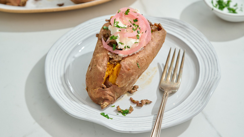 loaded beef sweet potato on a plate with a fork