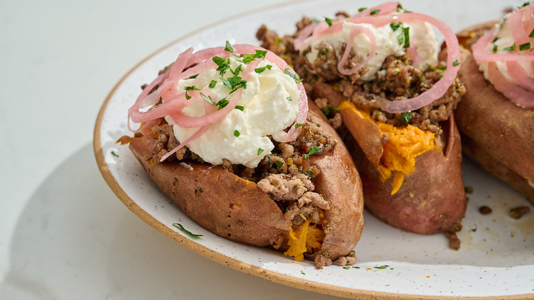 loaded beef sweet potatoes on a platter