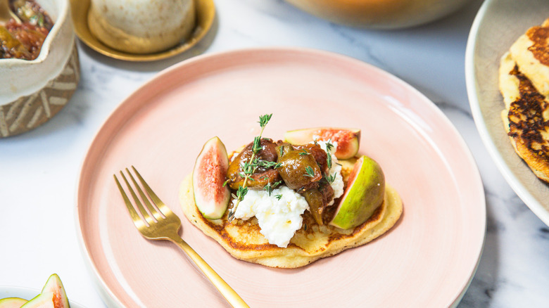 One goat cheese pancake on a plate.