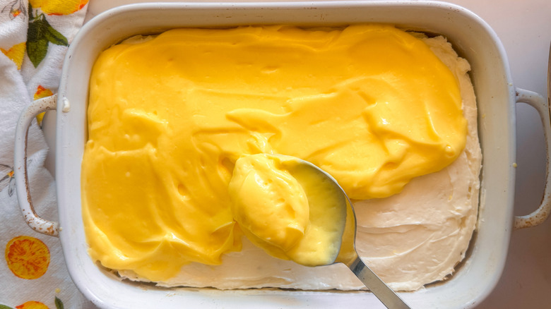 hand adding butter to bowl