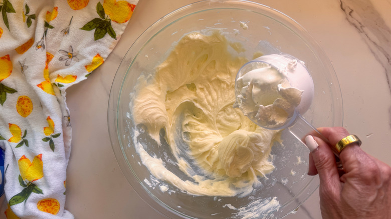 hand adding whipped cream