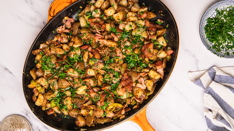 cowboy-style potatoes in a cast iron pan on a table