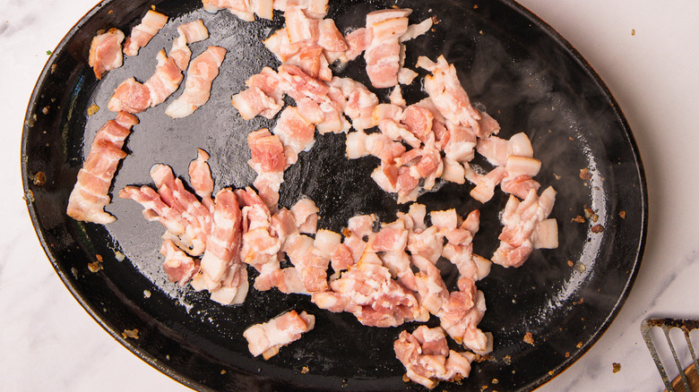 cast iron pan with bacon lardons