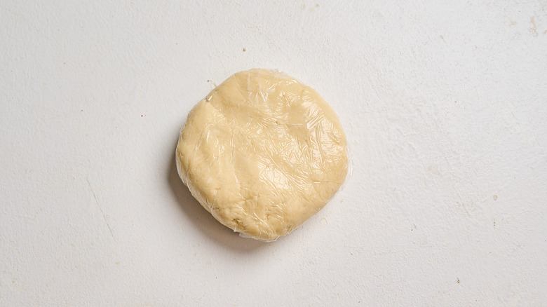 kneading dough into a disc shape