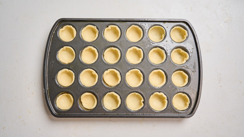 mini crusts pressed into mini muffin tin