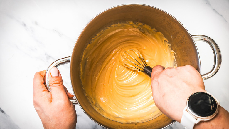 Whisking finished caramel in pot.