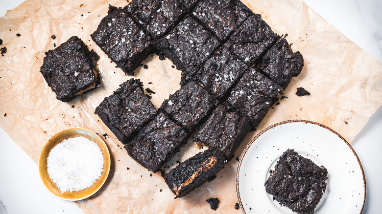 Overhead view of gooey caramel-filled brownies with coffee.