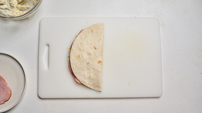 quesadilla folded in half on a cutting board