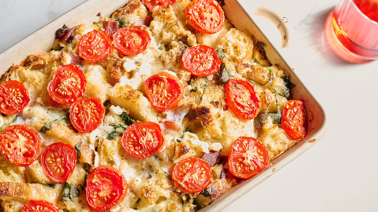 Cheesy tomato spinach breakfast strata in baking dish