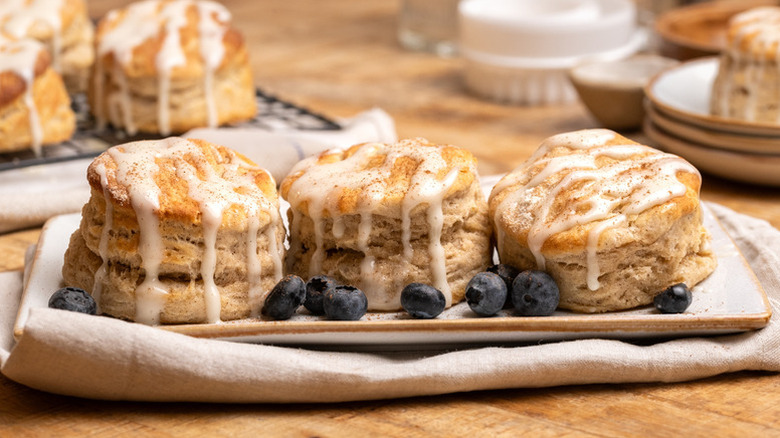 Three cinnamon biscuits on plate, topped with icing glaze