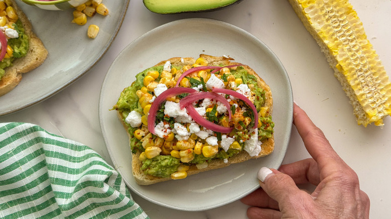 Elote-style avocado toast on plate