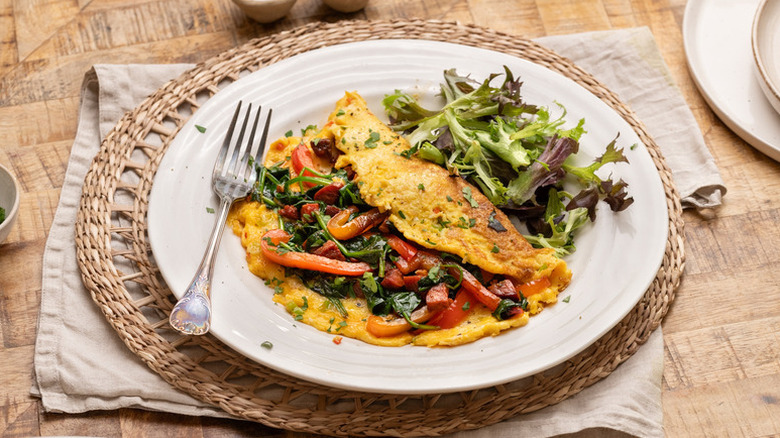 Chorizo and red pepper omelette on plate with salad leaves