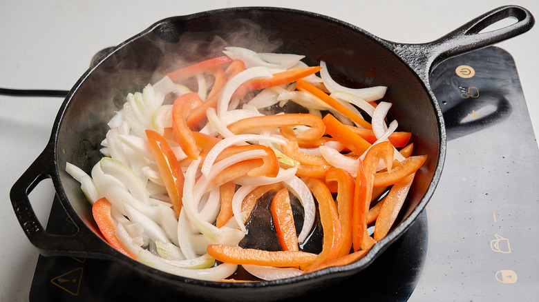 cooking the vegetables in a skillet