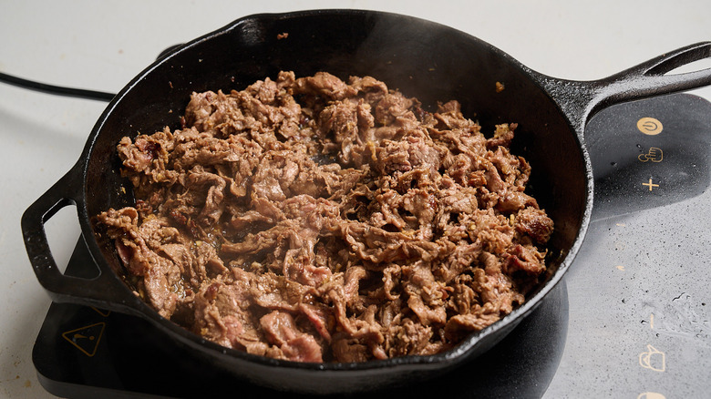 marinated beef in a skillet