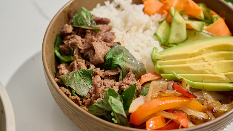 closeup of beef and peppers in thai basil beef bowl