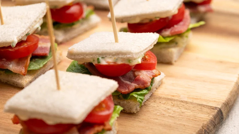 Mini BLT Sandwiches with Herby Mayo on wooden board