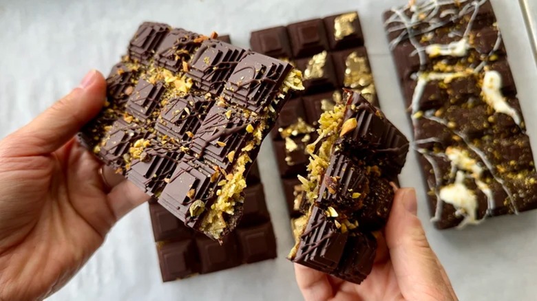 Holding two halves of Dubai chocolate bar