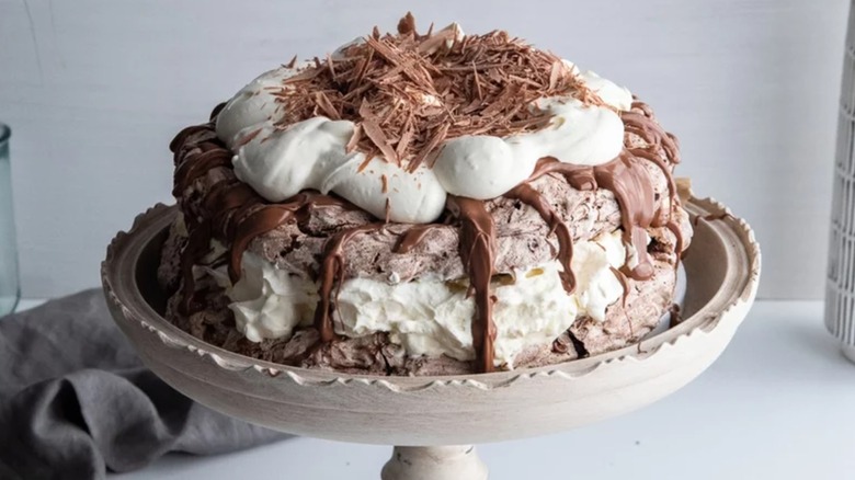 Chocolate pavlova on decorative cake stand