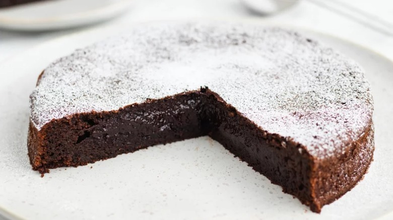 Flourless chocolate torte on white plate