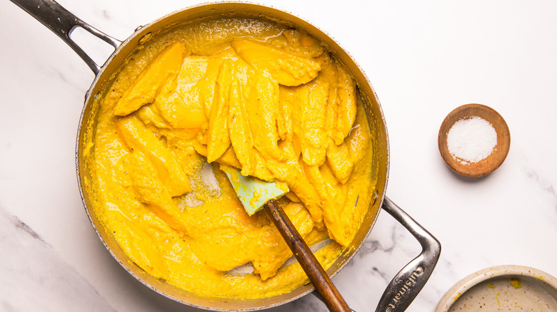 Mango curry in large pan.