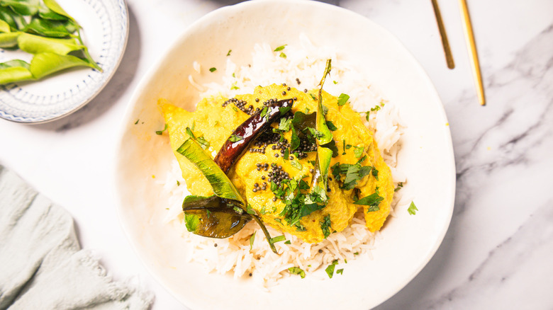 White bowl with rice topped with Goan ghotache sasav