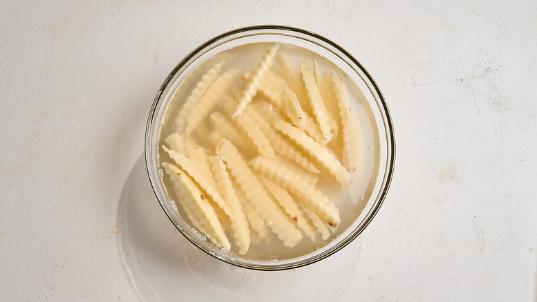 soaking potatoes in a bowl of water