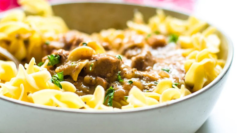 Close-up of slow-cooked beef tips and noodles in a bowl