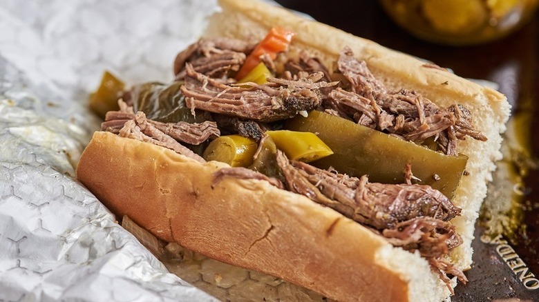 Slow-cooked beef in a sub sandwich with green bell peppers