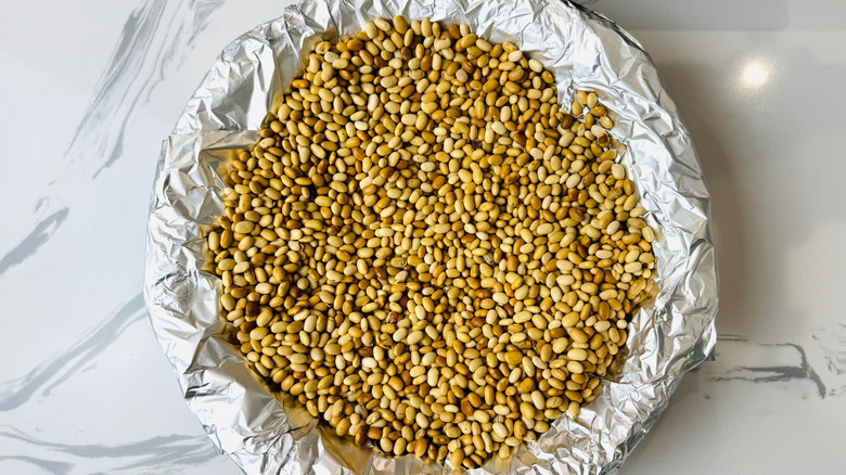 Foil-lined pie crust filled with dry beans