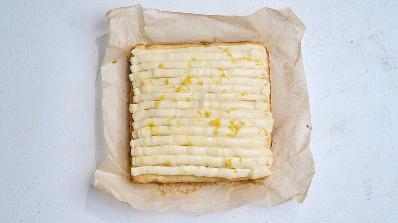 cake on a table topped with lemon zest