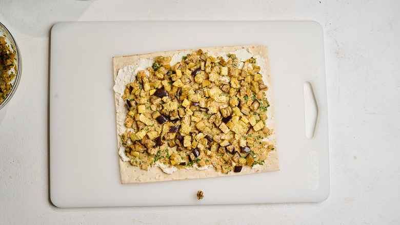 roasted vegetables layered over chickpeas and feta