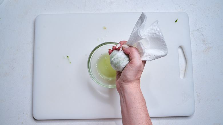 draining grated cucumber in a paper towel