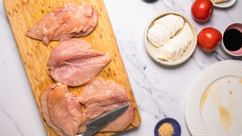 Cutting pockets inside raw chicken breasts