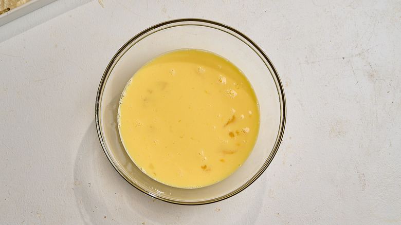 eggs and milk whisked together in a bowl
