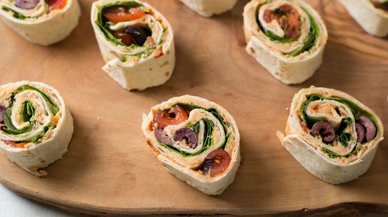 Tomato basil pinwheels on wooden board