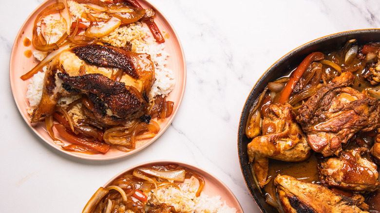 Pan with Filipino chicken next to two servings