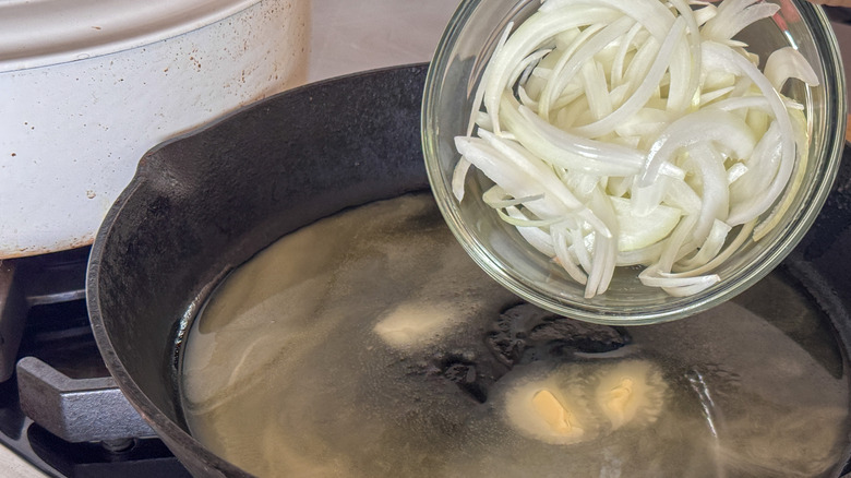 adding onion to pan with melted butter