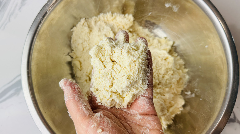 Butter being worked into dry ingredients for pie dough