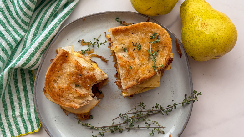 grilled cheese sandwich halved and topped wit thyme