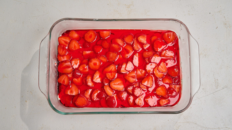 pressing pretzels into the base of a casserole dish