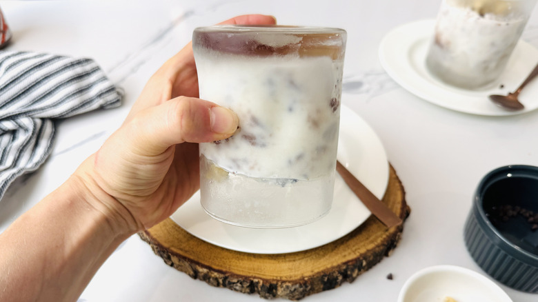 Holding a DIY cookie dough blizzard upside-down