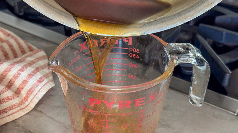 liquid pouring into measuring cup